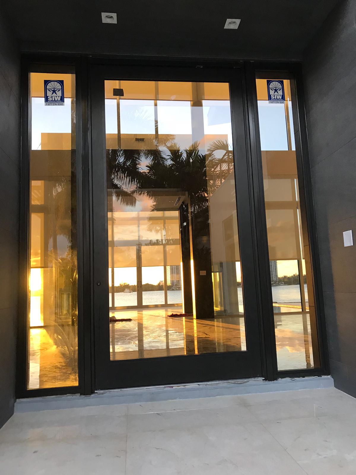 Modern black impact entry doors installed