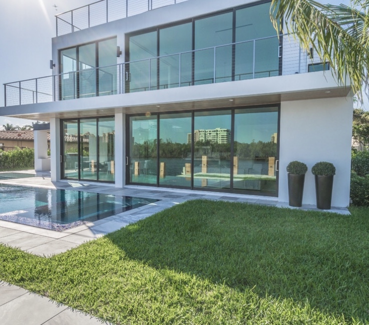 Modern impact sliding glass doors on a waterfront home